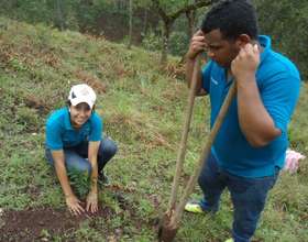 Students planting trees to receive their diploma