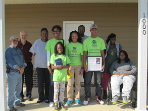 The Stanton family on the porch of their new home