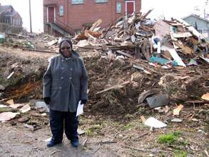 Ms. Patterson in front of her demolished home.