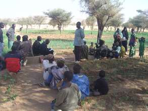 Families take a break from working in the field