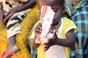 A child eating Plumpy'Nut in Burkina Faso