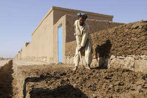 A man works diligently to construct his home