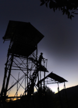 Dawn Patrol: A forest ranger on a watch tower