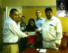 Rabia Khatun receiving check for insurance amount