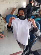 A student with her creation; a children clothing