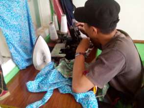 A student learning using sewing machine