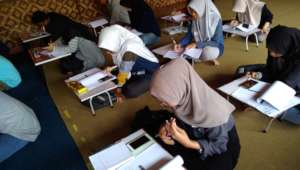 The students work on  Miss Yuli's assignments