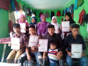 The sewing class students receiving certificates