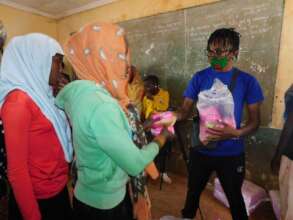 Passing out pads to community leaders