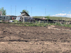 roto-tilled garden with walipini in background