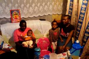 Bentado sits with Pauline & Ismael in their home.
