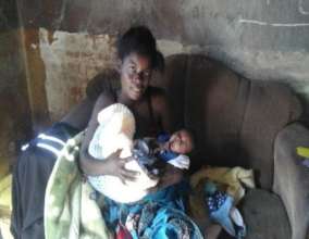 Betty, a happy mum, recipient of baby clothes