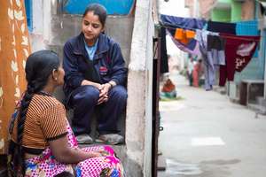 Gulafsha speaks to elders in the community