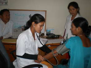 Young woman learns to take blood pressure
