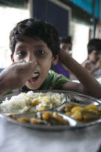 Boy in the shelter eating a nutritious meal