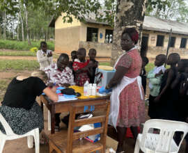KCIU staff carrying out vaccination
