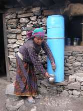 Woman collecting water from filter system