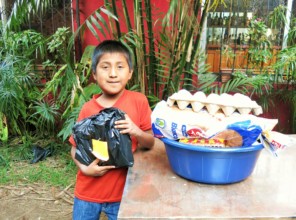 Pedro receiving his Christmas gift and basket
