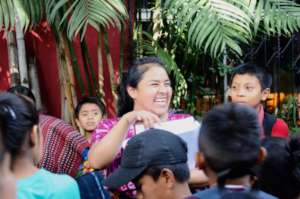 Johanny hands out forms at back-to-school meeting