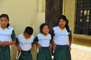 Students pose with their new athletic uniforms