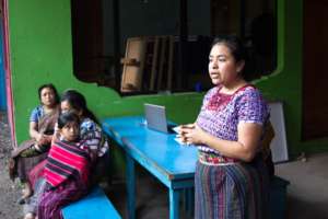 Johanny speaking at the school supplies drive
