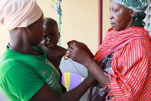 Massaguet: volunteer screens baby for malnutrition