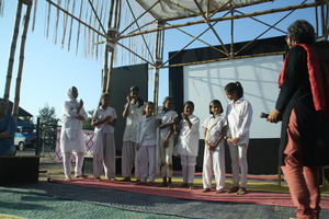 The girls explain their play to the audience