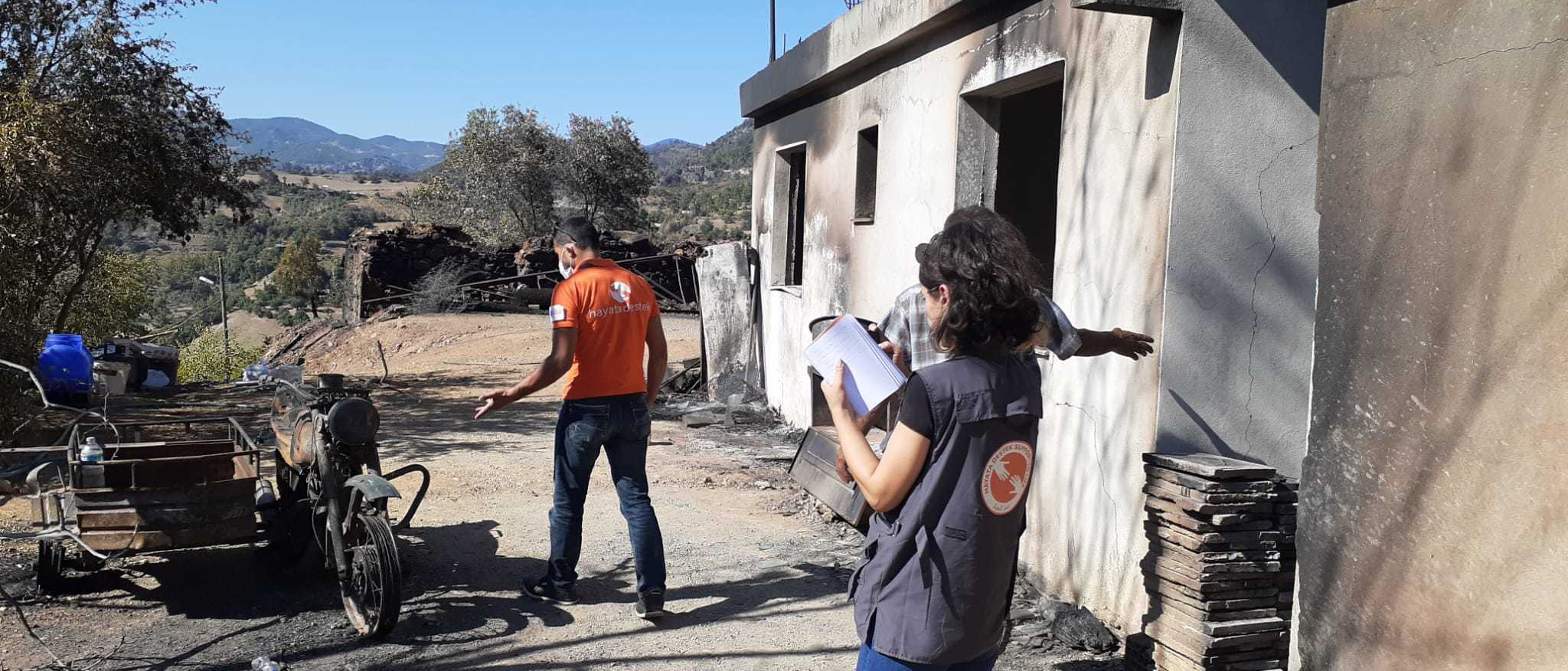 Turkey Wildfires Relief: man and woman survey impact of wildfires in Turkey.